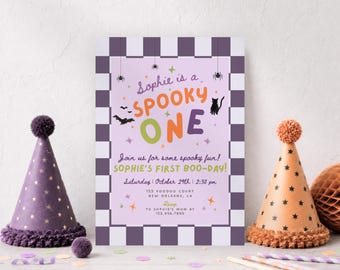 May include: A rectangular invitation card with a purple and white checkered border. The text reads: Sophie is a SPOOKY ONE, Join us for some spooky fun! SOPHIE'S FIRST BOO-DAY! Saturday October 29th 2:30 pm, 123 Voodoo Court New Orleans, LA.