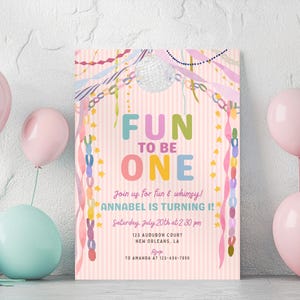 Puede incluir: Una tarjeta de invitación de cumpleaños con fondo de rayas rosa claro, una bola de discoteca, serpentinas coloridas y el texto FUN TO BE ONE, JOIN US FOR FUN & WHIMSY! ANNABEL IS TURNING 1! SATURDAY JULY 20TH AT 2:30 PM, 123 AUDUBON COURT NEW ORLEANS, LA, RSVP TO AMANDA AT 123-456-7890.