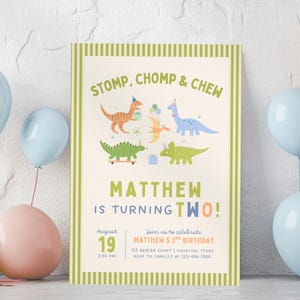 May include: A rectangular birthday invitation card with a light green striped border. The text reads STOMP, CHOMP & CHEW, MATTHEW IS TURNING TWO!, August 19, 2:30 PM, and event details. It features colorful illustrations of dinosaurs wearing party hats.