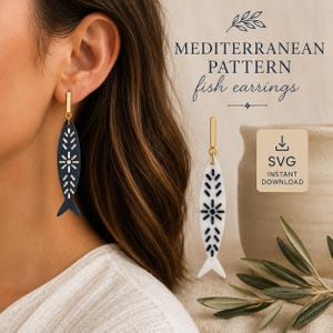 May include: Dangle earrings featuring a fish-shaped pendant with a Mediterranean pattern. One earring is dark blue with white detailing, and the other is white with dark blue detailing. Both have gold-tone hardware. Text reads: MEDITERRANEAN PATTERN fish earrings SVG INSTANT DOWNLOAD.