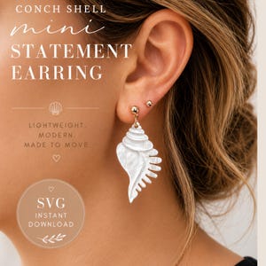May include: A close-up of a conch shell mini statement earring. The earring is white and hangs from a small gold stud. The text on the image reads "CONCH SHELL mini STATEMENT EARRING LIGHTWEIGHT. MODERN. MADE TO MOVE."