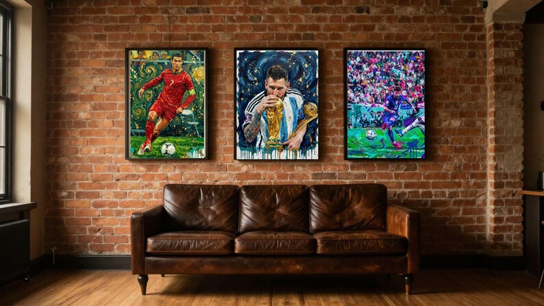 May include: Three framed rectangular wall art prints displayed above a brown leather sofa. The left print shows a soccer player in a red jersey, the center print shows a player kissing a gold trophy, and the right print shows a player on a field.