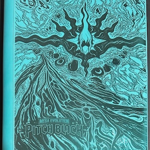 May include: A turquoise binder featuring a dark, intricate graphic design of swirling patterns and a central flame-like emblem. The text "MEGA EVOLUTION" and "PITCH BLACK" is printed in a stylized font at the bottom left of the front cover.