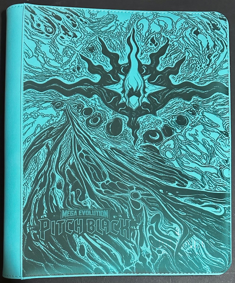 May include: A turquoise binder featuring a dark, intricate graphic design of swirling patterns and a central flame-like emblem. The text "MEGA EVOLUTION" and "PITCH BLACK" is printed in a stylized font at the bottom left of the front cover.
