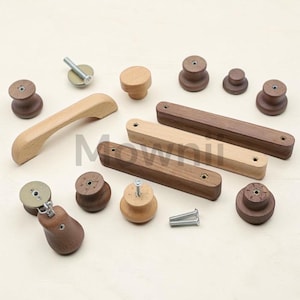 May include: A collection of wooden cabinet hardware, including knobs and pulls. The hardware is in various shapes and sizes, with a natural wood finish and dark brown wood. Some pieces include screws for installation. The word "Mowwii" is visible in the image.