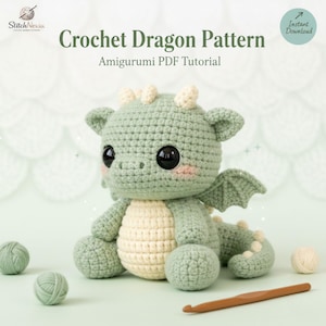 May include: A crocheted dragon amigurumi with large black eyes, sitting on a light green surface. The dragon is primarily light green with cream-colored accents. The image includes the text "Crochet Dragon Pattern" and "Amigurumi PDF Tutorial".