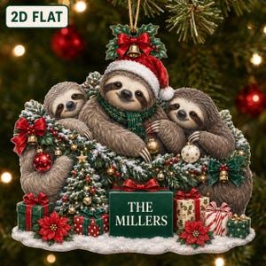 May include: A 2D flat Christmas ornament featuring three brown sloths wearing a red Santa hat and a green scarf. The sloths are surrounded by pine branches, red bows, gold bells, and ornaments. A green gift box in the centre displays the text THE MILLERS.