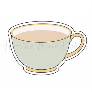 May include: A light green teacup cookie cutter with a beige interior and a beige handle. The rim and base of the cup are also beige. The text "Hearth & Home Bak" is written on the side of the cup.