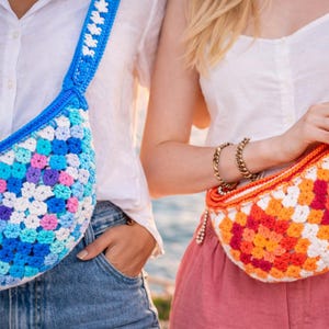 May include: Two crochet bags in a granny square pattern. One bag is blue with white, pink, and purple accents, and the other is orange, red, and white. Both bags have matching straps and are worn over the shoulder.