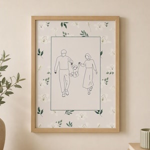 Puede incluir: Un marco de madera rectangular que contiene una impresión con una ilustración de líneas central de dos adultos sosteniendo las manos de un niño. El fondo de la impresión presenta un patrón repetitivo de flores de lirio blancas y hojas verdes.