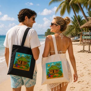 May include: Two tote bags, one black and one off-white, each featuring a vibrant illustration of a tropical hut, vegetables, and palm trees. The bags are carried by people on a sandy beach. A sign in the background reads "Live Laugh Beach".