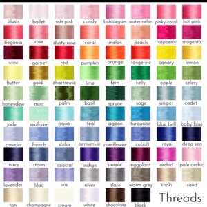May include: A color chart displaying a wide array of thread colors, including shades of pink, red, orange, yellow, green, blue, purple, and neutral tones. The word "Threads" is printed at the bottom.