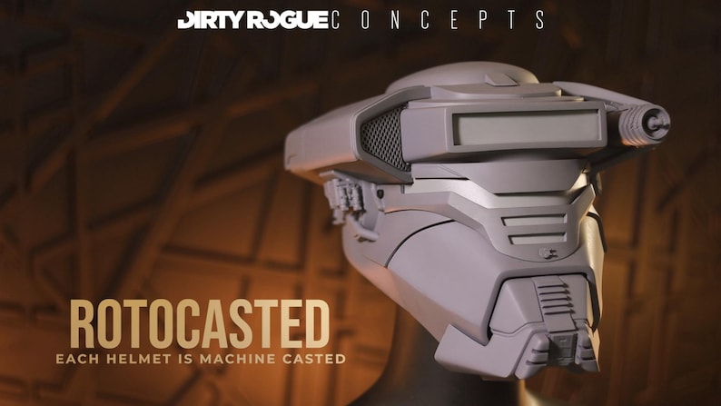 May include: A gray, futuristic helmet with a visor and intricate details. The helmet is labeled "ROTOCASTED" with the text "EACH HELMET IS MACHINE CASTED" below. The brand name "DIRTY ROGUE CONCEPTS" is at the top.