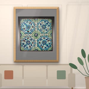 May include: A framed wall art piece featuring a square grid of four ceramic tiles. The tiles display a repeating floral pattern in shades of deep blue, turquoise, and green, with intricate petal and leaf motifs set against a white background.