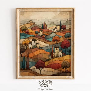 Peut inclure: Impression d'art encadrée à l'aquarelle d'un paysage toscan. L'œuvre présente des collines ondulantes dans des tons orange, marron et bleu, avec de petits bâtiments blancs et des arbres colorés. Le cadre est de couleur or clair. Le texte "Vintage Vine Prints" est en bas.