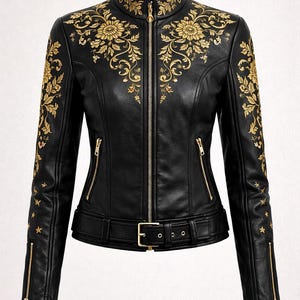 May include: Black leather jacket with gold floral embroidery. It has a zip-up front, zipped pockets, and a belted waist. The sleeves feature gold star accents and zips at the cuffs. Measurements are in cm.