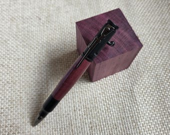 Bold Purpleheart bolt-action pen with Black Enamel trim—sleek, smooth, and one-of-a-kind.