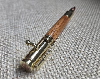 Red Zebrawood bolt-action pen with Gold trim—dramatic grain, luxury look, gift-ready.