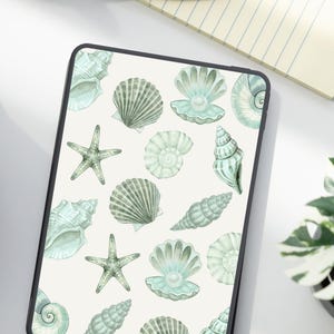 May include: A tablet case featuring a pattern of watercolor seashells and starfish in shades of green and white. The design includes various shell types and starfish scattered across a cream-colored background. The case has a black border.