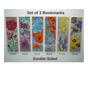 May include: A set of 3 double-sided bookmarks featuring watercolor floral illustrations. The text Set of 3 Bookmarks and Double-Sided is printed on the image. Each bookmark displays different flower patterns in red, blue, orange, and yellow hues.