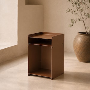 May include: A matte brown metal side table featuring a rectangular top surface with raised edges, a single open storage shelf below, and a large open compartment at the base. The structure is held together by visible screws on the side panels.