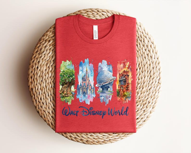 May include: Red t-shirt featuring watercolor illustrations of iconic Walt Disney World landmarks: the Tree of Life, Cinderella Castle, Spaceship Earth, and the Tower of Terror. The words "Walt Disney World" are written in blue script below the images.