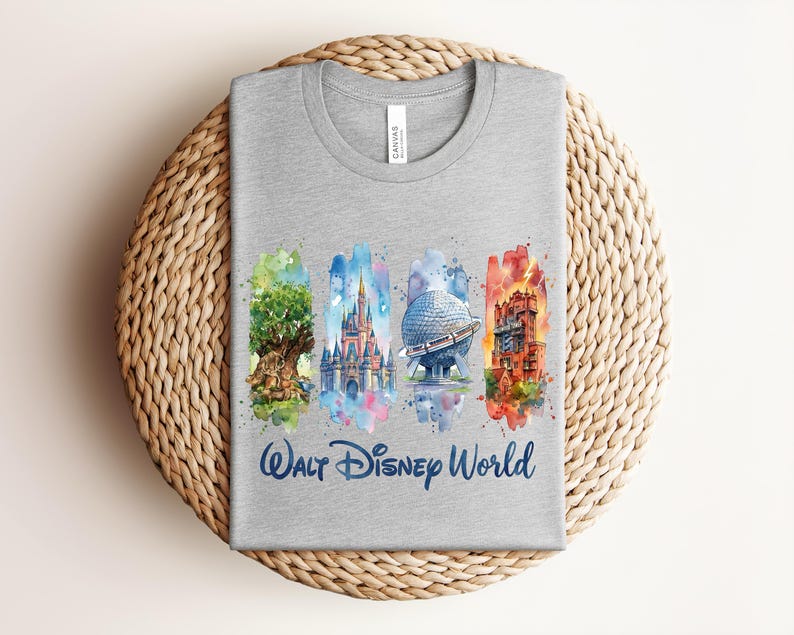 May include: A gray t-shirt featuring watercolor illustrations of iconic Walt Disney World landmarks: the Tree of Life, Cinderella Castle, Spaceship Earth, and the Tower of Terror. The words "Walt Disney World" are printed in blue script below the images.