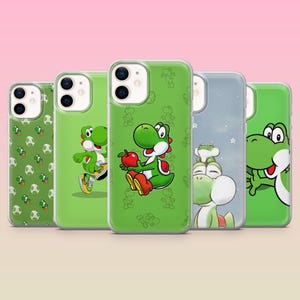 May include: A collection of five phone cases featuring the character Yoshi from the Super Mario franchise. The cases are green, with various designs including Yoshi holding an apple, and Yoshi-themed patterns.