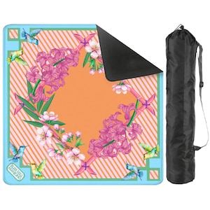 May include: A square game mat with a light blue border and an orange striped center featuring pink hyacinth flowers, cherry blossoms, and hummingbirds. The text "BLISS HILL MAHJONG" is printed in the corner. Includes a black carrying bag.