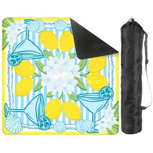 May include: A square picnic blanket with a lemon and cocktail design. The blanket features yellow lemons, blue cocktail glasses, white flowers, and seashells on a blue and white striped background. A black carrying bag is included.