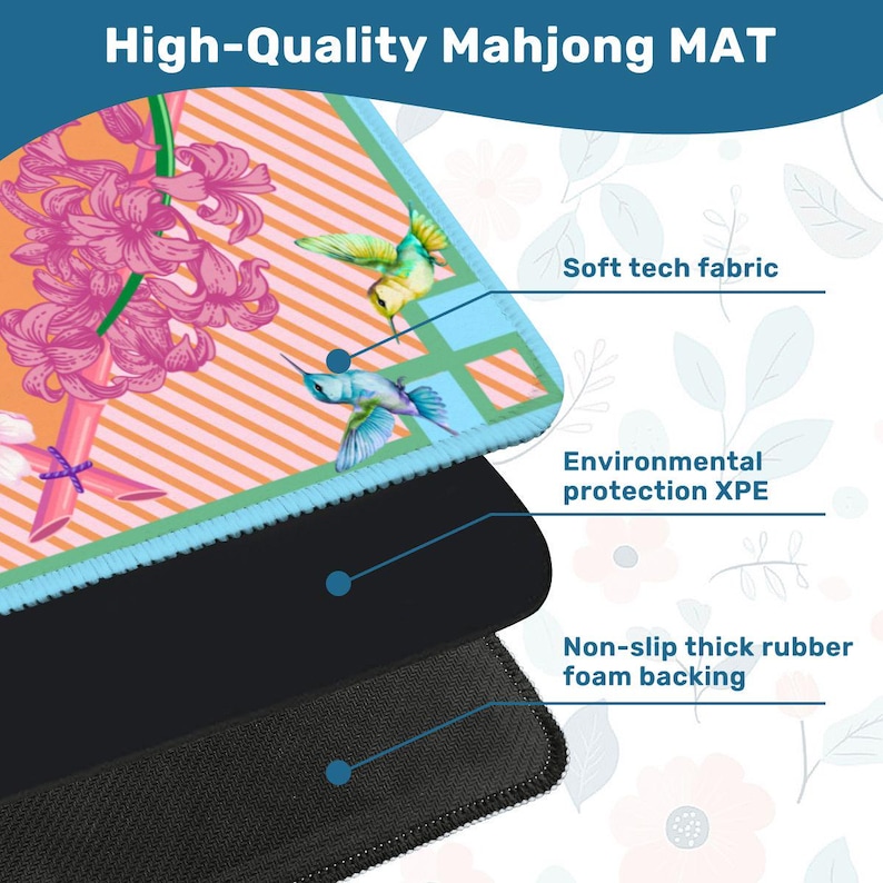 May include: A rectangular Mahjong mat featuring a vibrant orange and light blue striped pattern with pink hyacinth flowers and two hummingbirds. The mat displays three layers: a soft tech fabric top, an XPE middle, and a non-slip rubber foam backing.