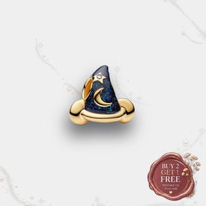May include: A gold charm shaped like a wizard hat with a dark blue glittery surface. The hat features a gold crescent moon and a gold star with a small clear stone in the centre. A wax seal graphic in the corner reads BUY 2 GET 1 FREE.