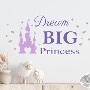 May include: Purple castle silhouette with a heart in the center and the text "Dream BIG Princess" with silver stars around the castle.
