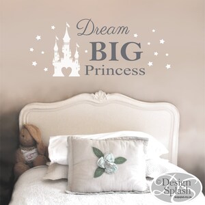 May include: White castle silhouette with a heart in the center, surrounded by white stars. The text "Dream BIG Princess" is in gray lettering.