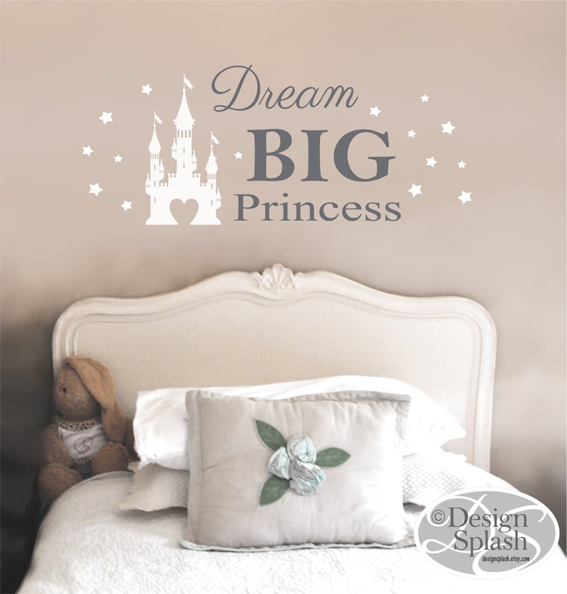 May include: White castle silhouette with a heart in the center, surrounded by white stars. The text "Dream BIG Princess" is in gray lettering.