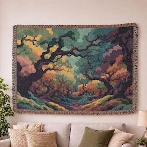 May include: A rectangular woven tapestry featuring a dense forest landscape with dark, gnarled tree trunks and branches set against a backdrop of layered foliage in shades of teal, mustard yellow, deep purple, and muted orange with fringed edges.
