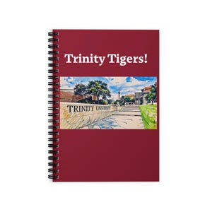 May include: A spiral-bound notebook with a burgundy cover. The cover features the text "Trinity Tigers!" in white, above a watercolor image of Trinity University. The image includes the text "Trinity University".