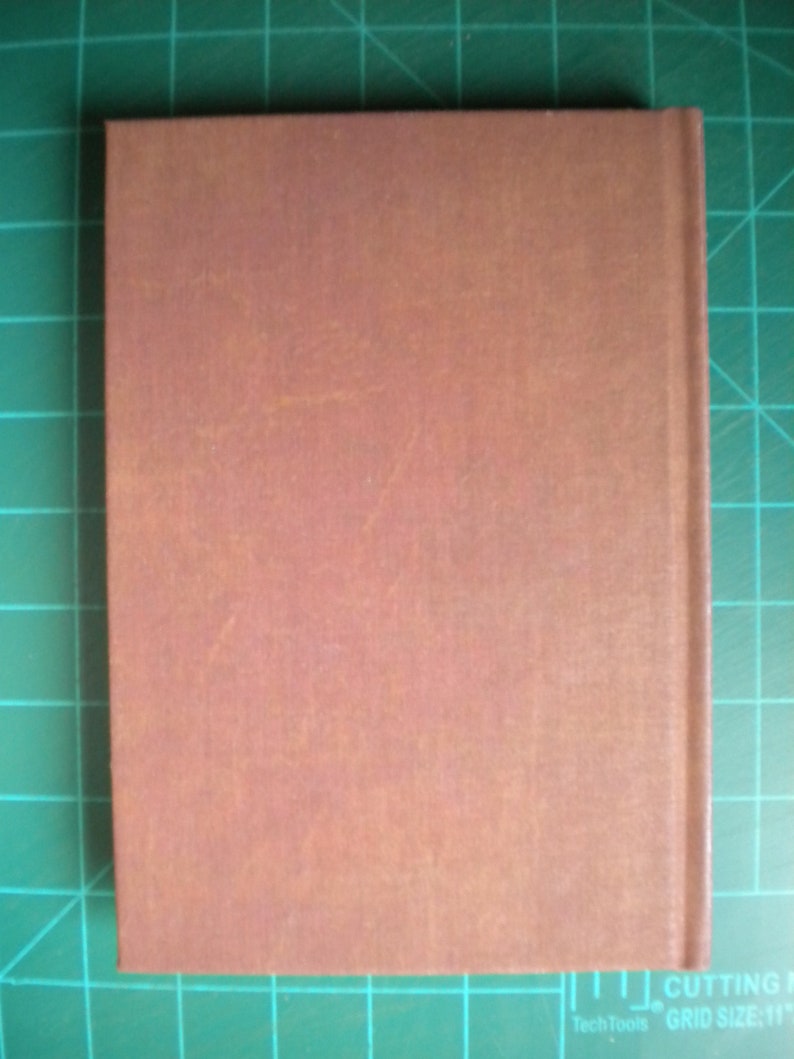 May include: A brown leather-bound journal with a textured cover.