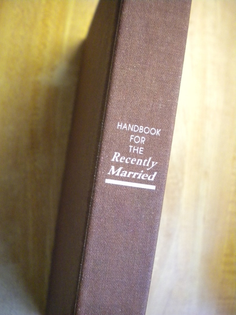 May include: A brown book with the title "Handbook for the Recently Married" printed in white on the cover.