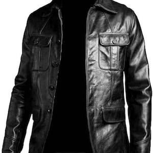 May include: Black leather jacket with a collared neckline, button closure, and multiple pockets. The jacket has a classic design, suitable for various occasions. The leather appears to be slightly distressed, adding to its vintage appeal.