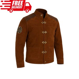 May include: Brown suede jacket with a stand-up collar, shoulder patches, and three toggle closures. Features a patch on the left sleeve and two front pockets. The jacket is a medium brown colour.