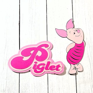 May include: Pink Piglet character and text cutout. The Piglet character is pink with a striped dress and is smiling. The text cutout says "Piglet" in a retro font, with a pink outline.