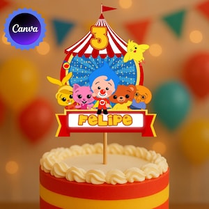 May include: A colorful cake topper featuring a circus tent design with the number 3 and the name "Felipe". The topper includes cartoon characters and is placed on top of a cake with red, yellow, and white frosting.