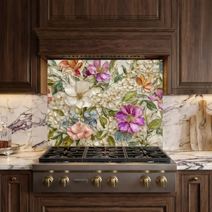 May include: A decorative floral splashback featuring a variety of colourful flowers, including white, pink, purple, and orange blooms, is installed above a stainless steel gas hob. The kitchen has dark wood cabinets and marble worktops.