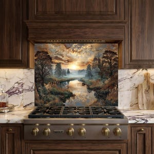 May include: A kitchen backsplash featuring a scenic landscape painting of a river at sunset. The artwork depicts trees, water, and a colorful sky. The backsplash is installed above a stainless steel gas range with brass knobs, set within dark wood cabinetry.