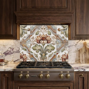 May include: Decorative kitchen backsplash tiles with a floral design in shades of orange, green, and blue. The tiles are set above a stainless steel gas range with brass knobs. The kitchen features dark wood cabinetry and marble countertops.