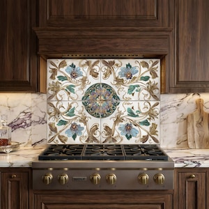 May include: Decorative kitchen backsplash tiles featuring a floral design with blue, green, and gold accents. The tiles are installed above a stainless steel gas range with brass knobs, set against dark wood cabinetry and a marble countertop.