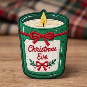 May include: An embroidered patch shaped like a green candle in a jar. The candle has a yellow flame, a red ribbon bow, and a white label with the red text Christmas Eve above a small red bow and green leaves. The design features dark green borders.