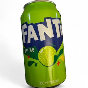 May include: A green Fanta melon soda can with the word "Fanta" in white letters on a blue background. The can features a melon graphic and text in Korean. The can contains 350 ml of soda.