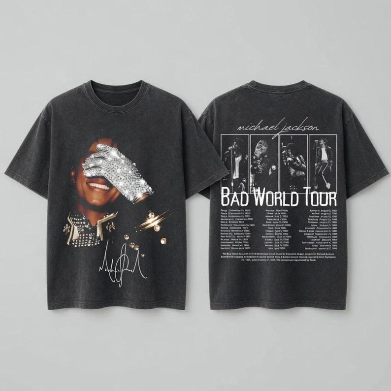 May include: Dark gray t-shirt featuring a portrait of Michael Jackson with a sparkling glove covering his eyes. The shirt has the text "Bad World Tour" and a list of tour dates on the back. The shirt has a vintage, distressed look.